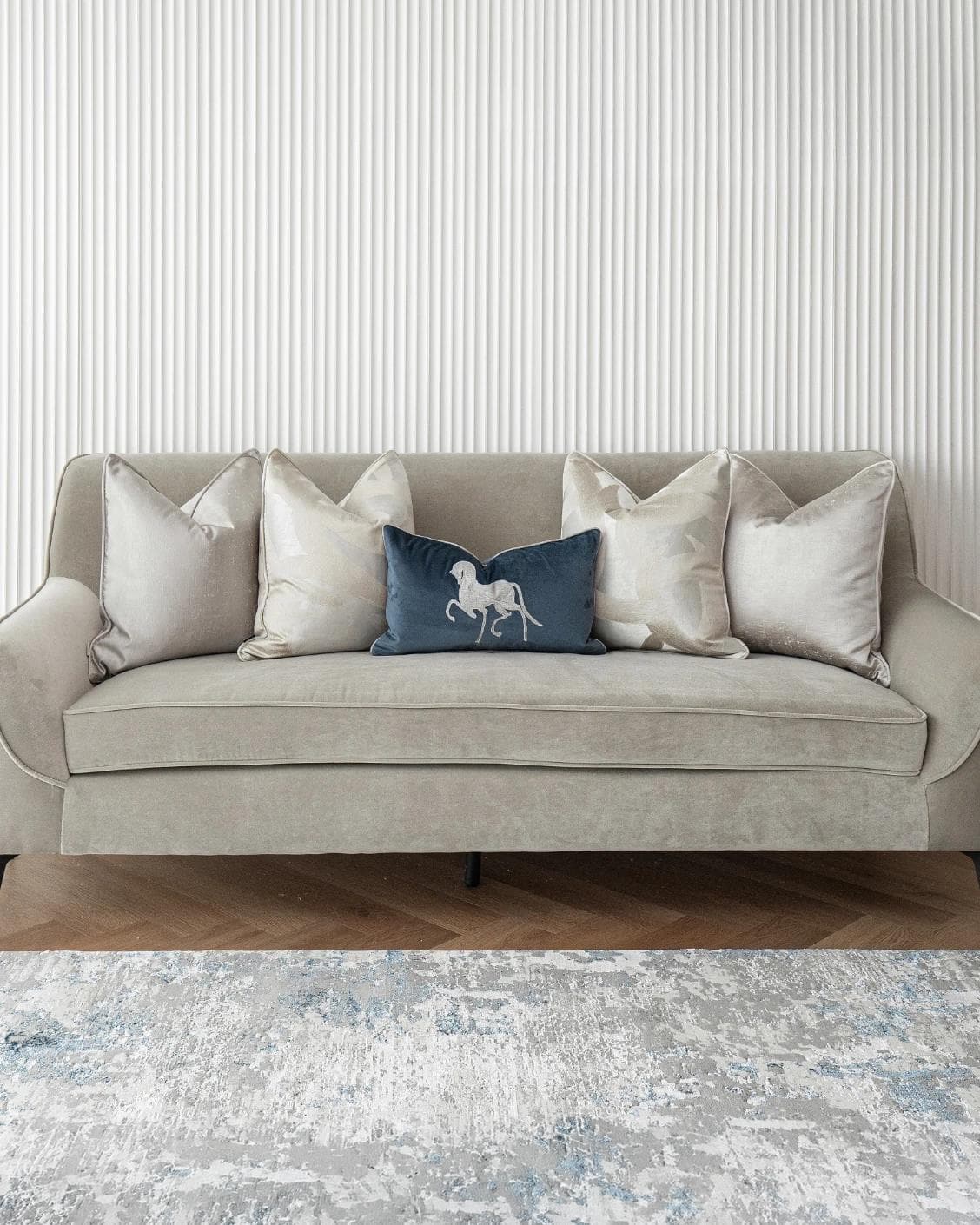 Miguel Bundle cushion in silver, beige and blue, shown in a lifestyle front view as image 2
