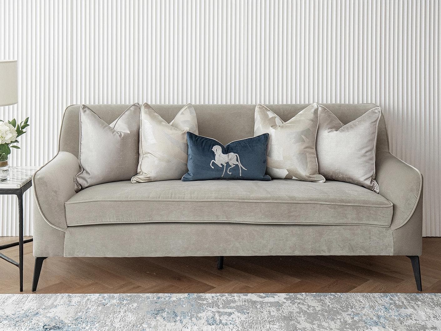 Miguel Bundle cushion in silver, beige and blue, shown in a lifestyle front view as image 2