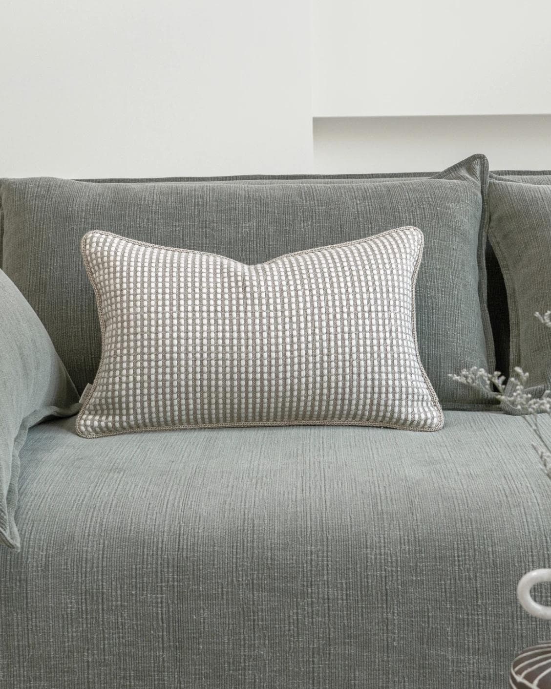 Shea Laurent II cushion in beige, shown in a lifestyle front view as image 2