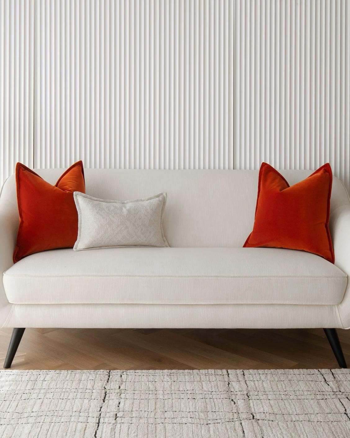 Jayme Bundle cushion in white and orange, shown in a lifestyle front view as image 4