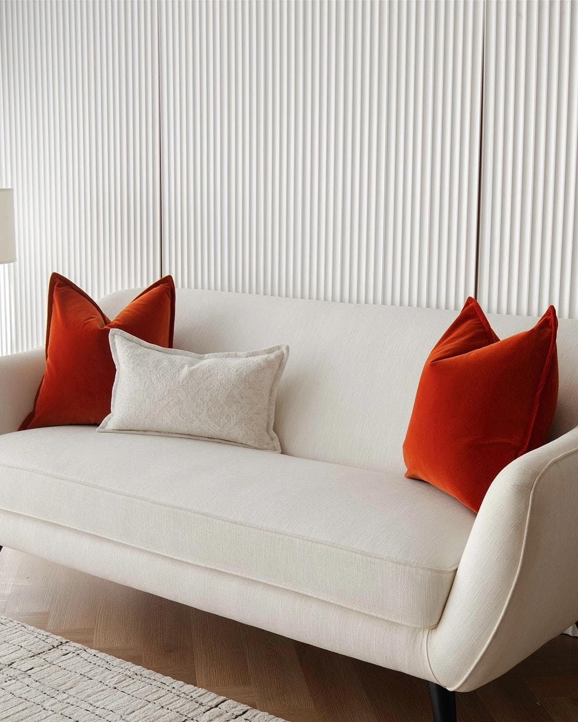 Jayme Bundle cushion in white and orange, shown in a lifestyle right view as image 2
