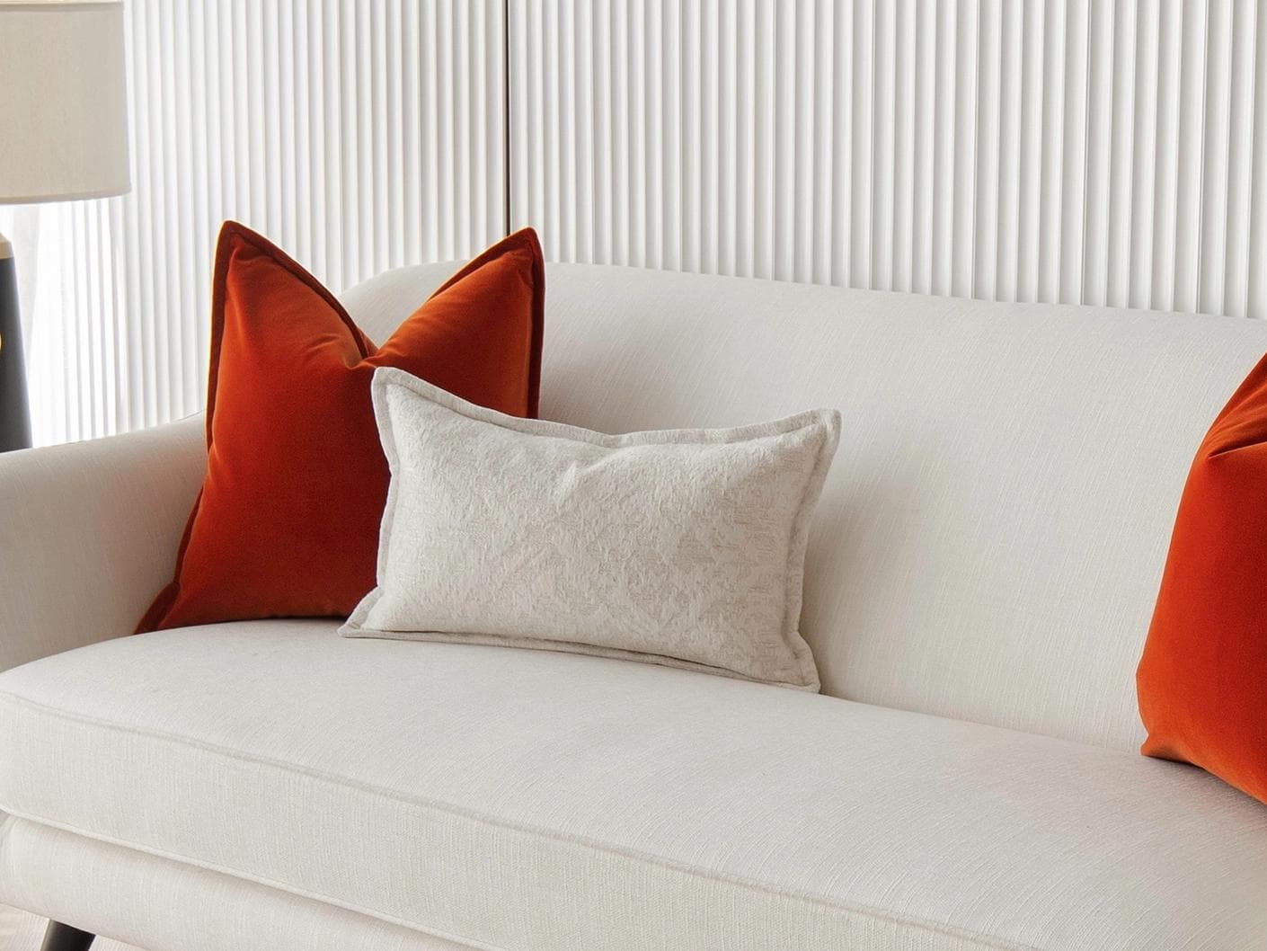 Jayme Bundle cushion in white and orange, shown in a lifestyle right view as image 2