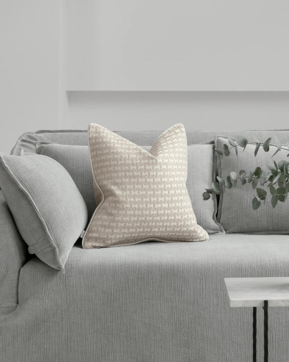 Sia Laurent cushion in ivory, shown in a lifestyle front view as image 4
