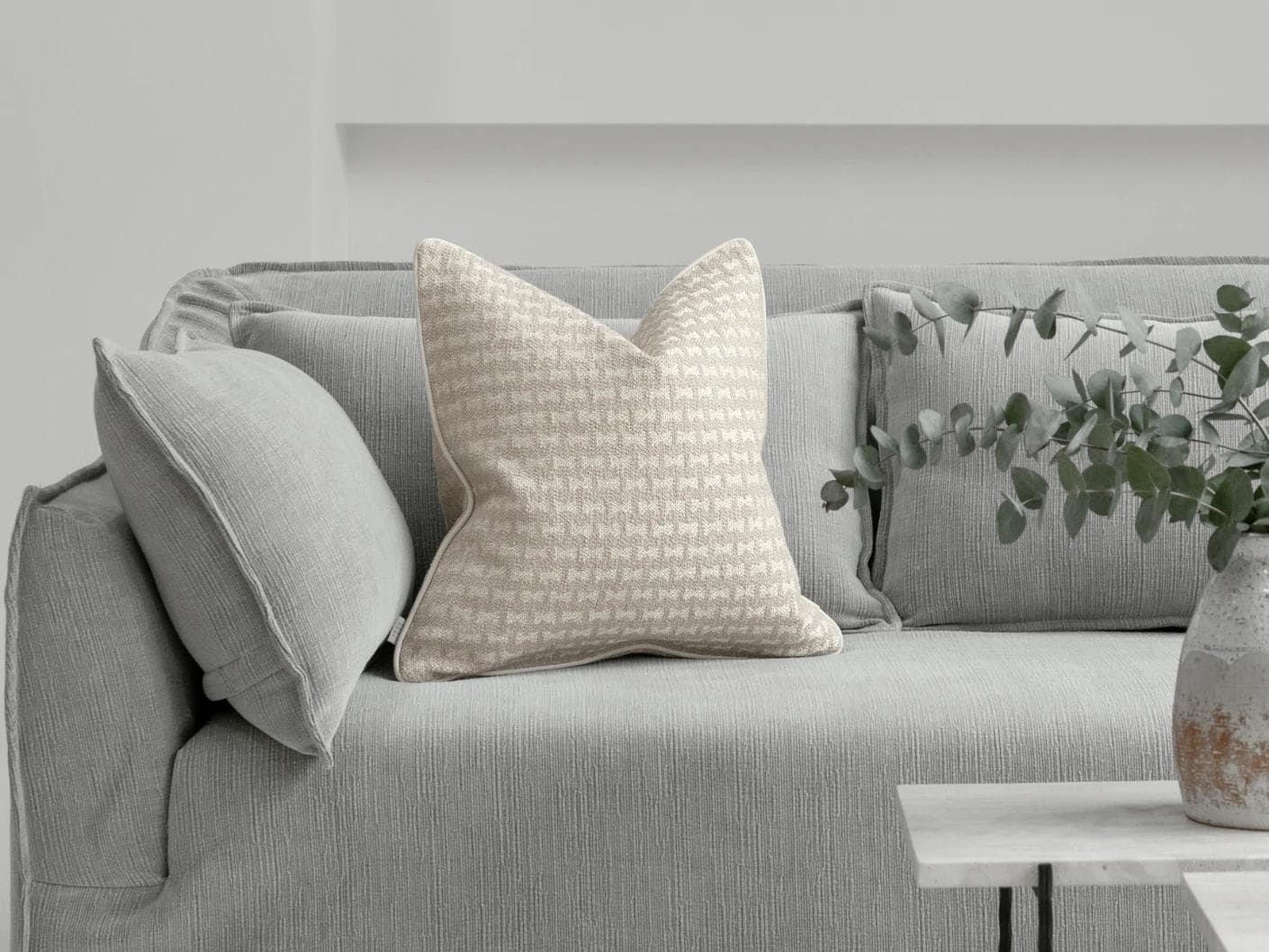 Sia Laurent cushion in ivory, shown in a lifestyle front view as image 4