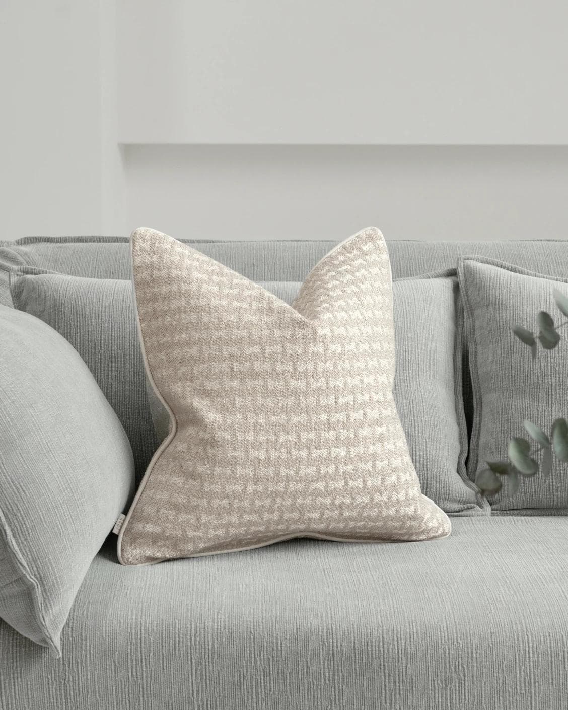 Sia Laurent cushion in ivory, shown in a lifestyle front view as image 2