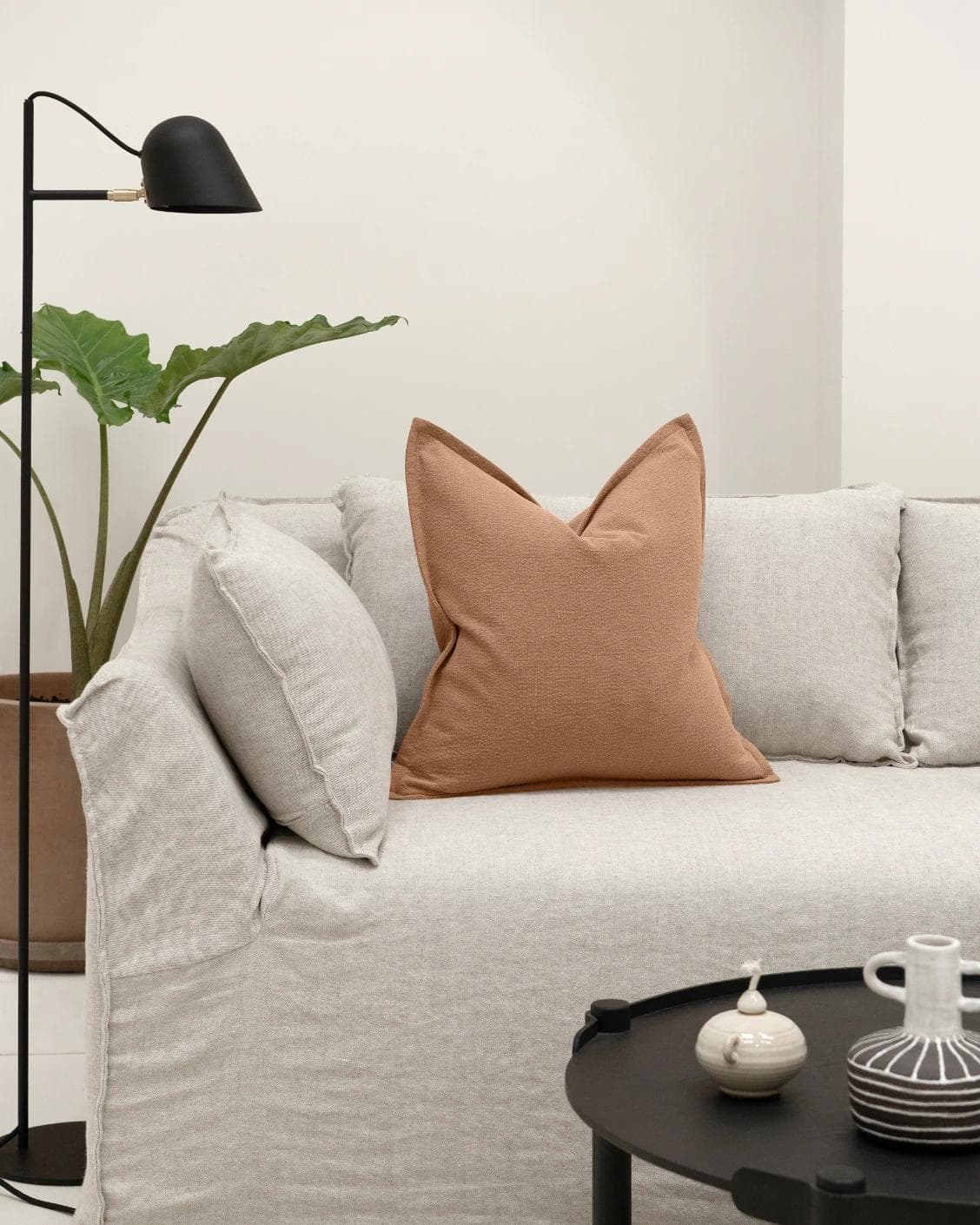 Siena Alecia cushion in orange, shown in a lifestyle front view as image 4