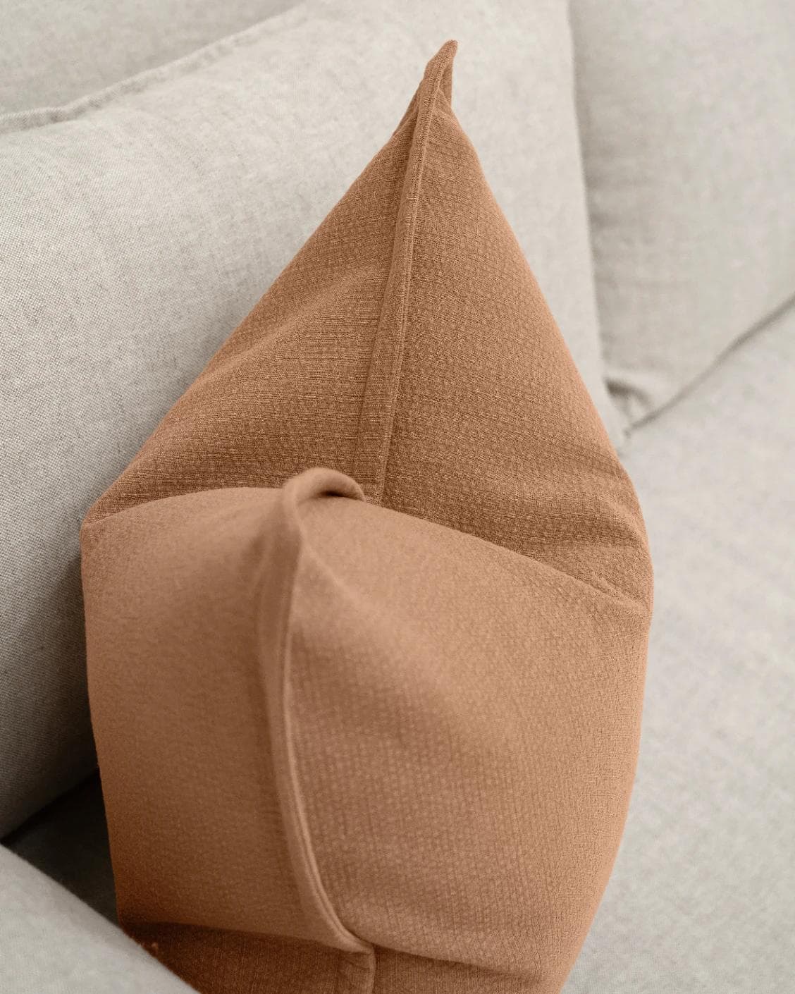 Siena Alecia cushion in orange, shown in a lifestyle top view as image 5