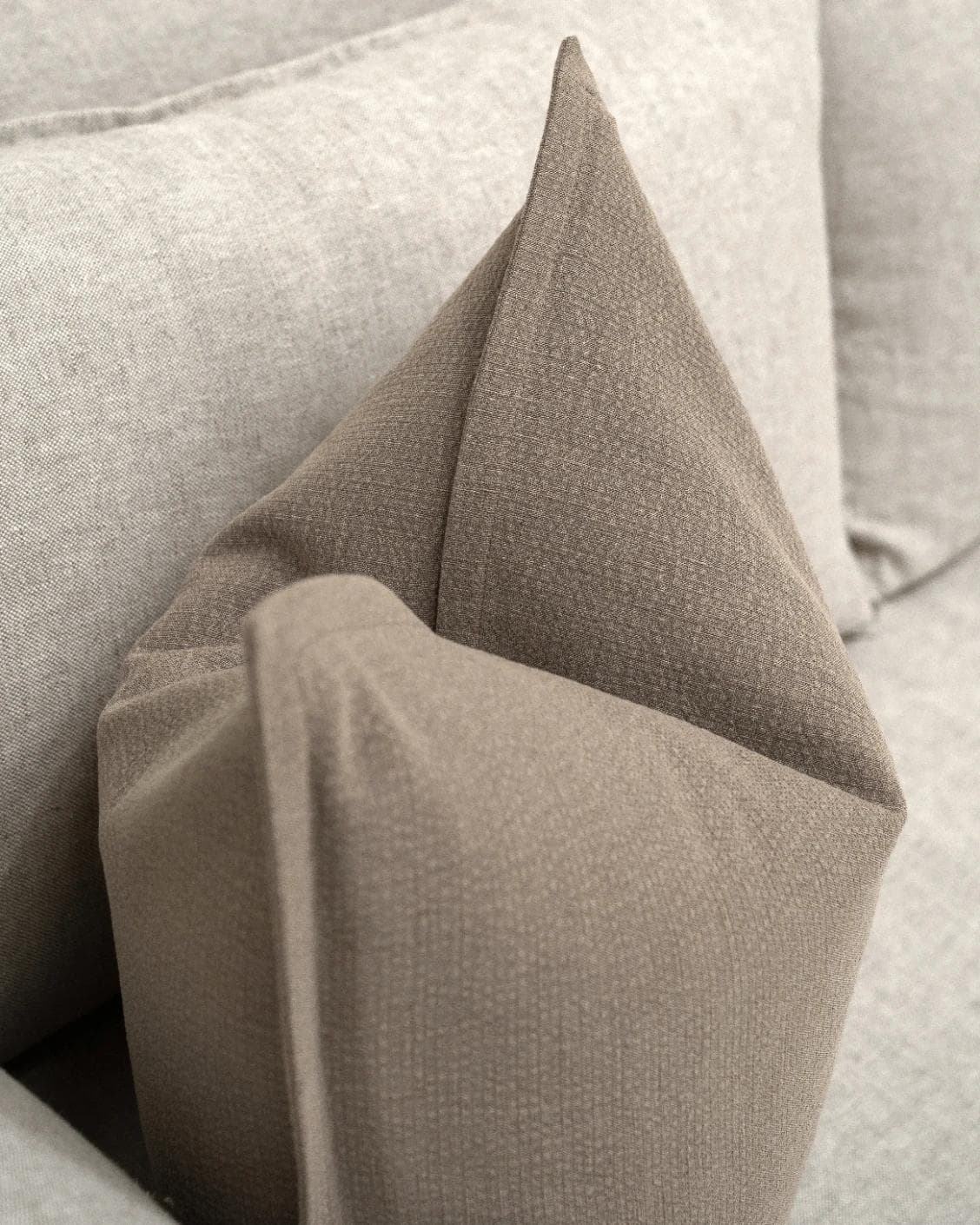 Siena Braun cushion in beige and grey, shown in a lifestyle top view as image 5