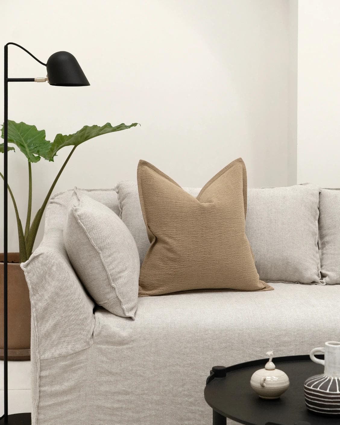 Siena Laurent cushion in brown, shown in a lifestyle front view as image 4