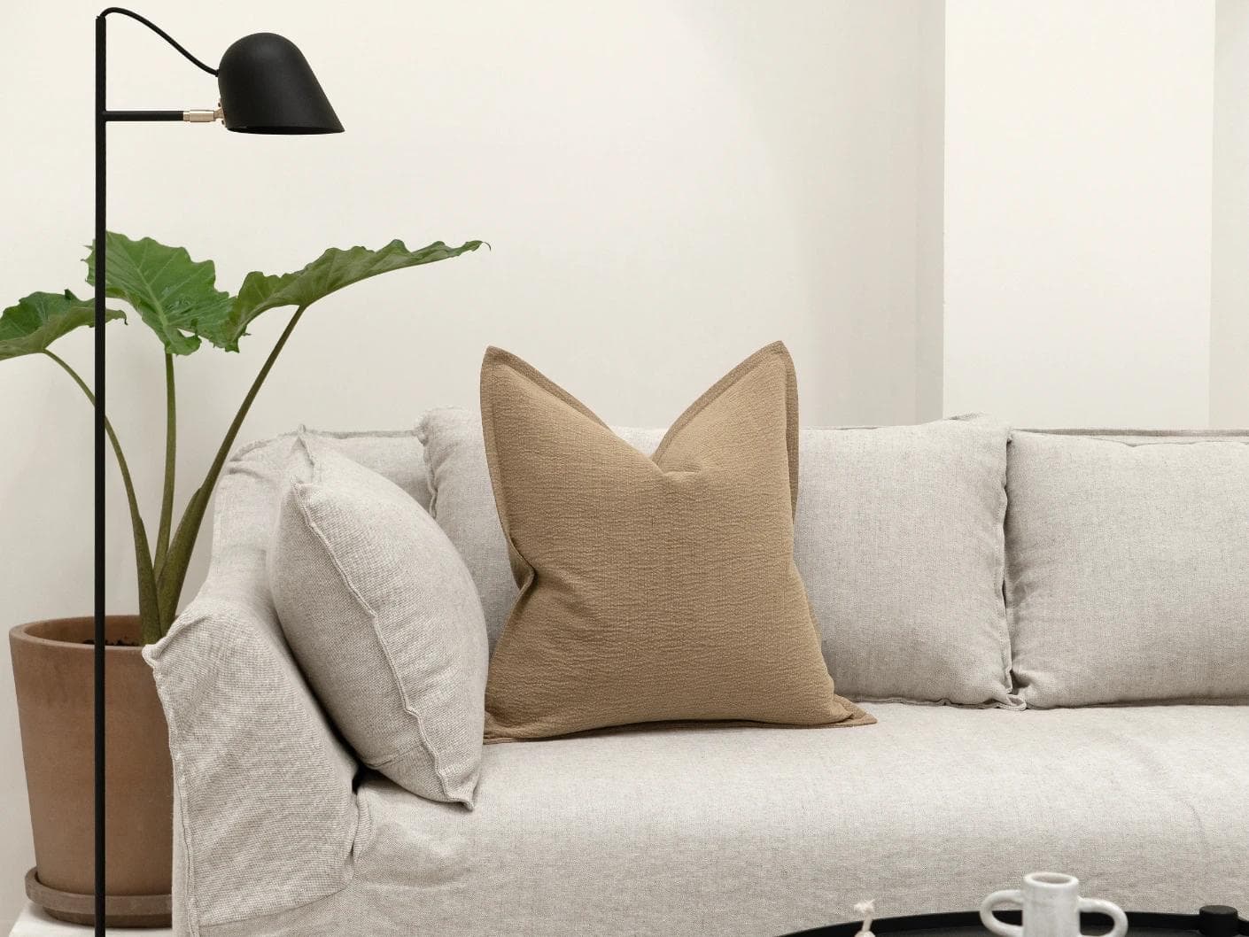 Siena Laurent cushion in brown, shown in a lifestyle front view as image 4