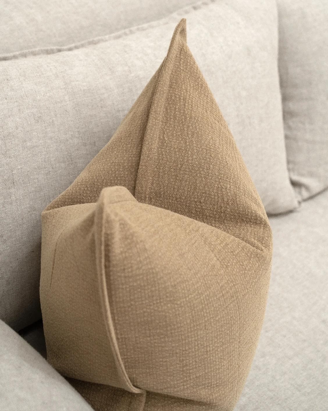 Siena Laurent cushion in brown, shown in a lifestyle top view as image 5