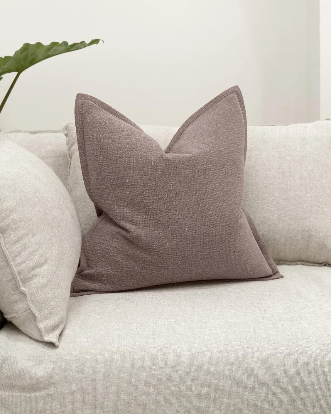 Siena Mauveine cushion in purple and taupe, shown in a lifestyle front view as image 2