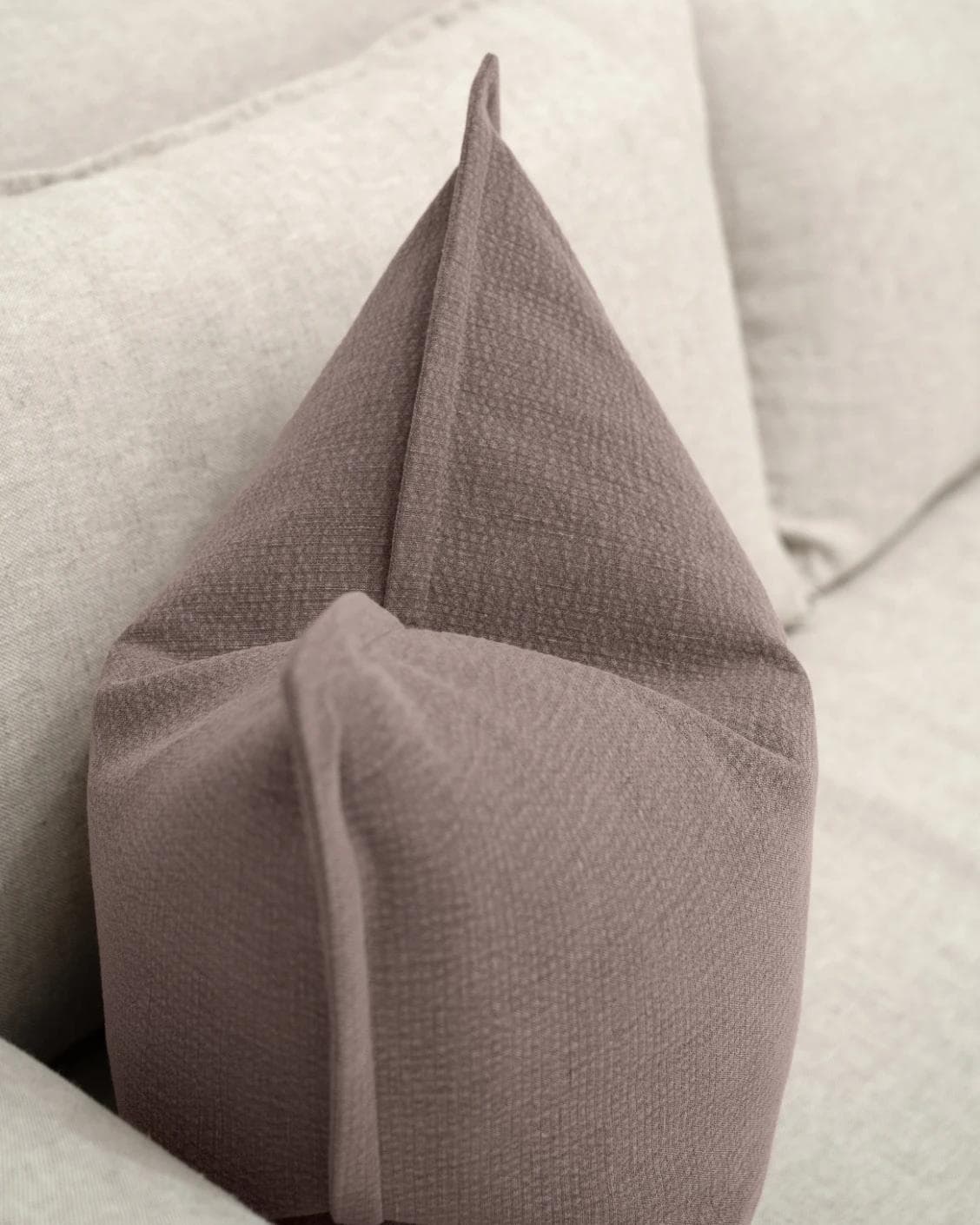Siena Mauveine cushion in purple and taupe, shown in a lifestyle top view as image 5