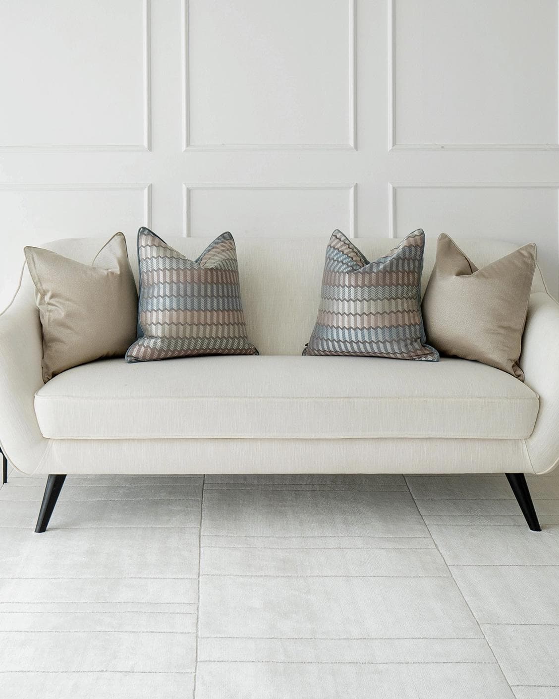 Evie Bundle cushion in silver, blue, gold and beige, shown in a lifestyle front view as image 4