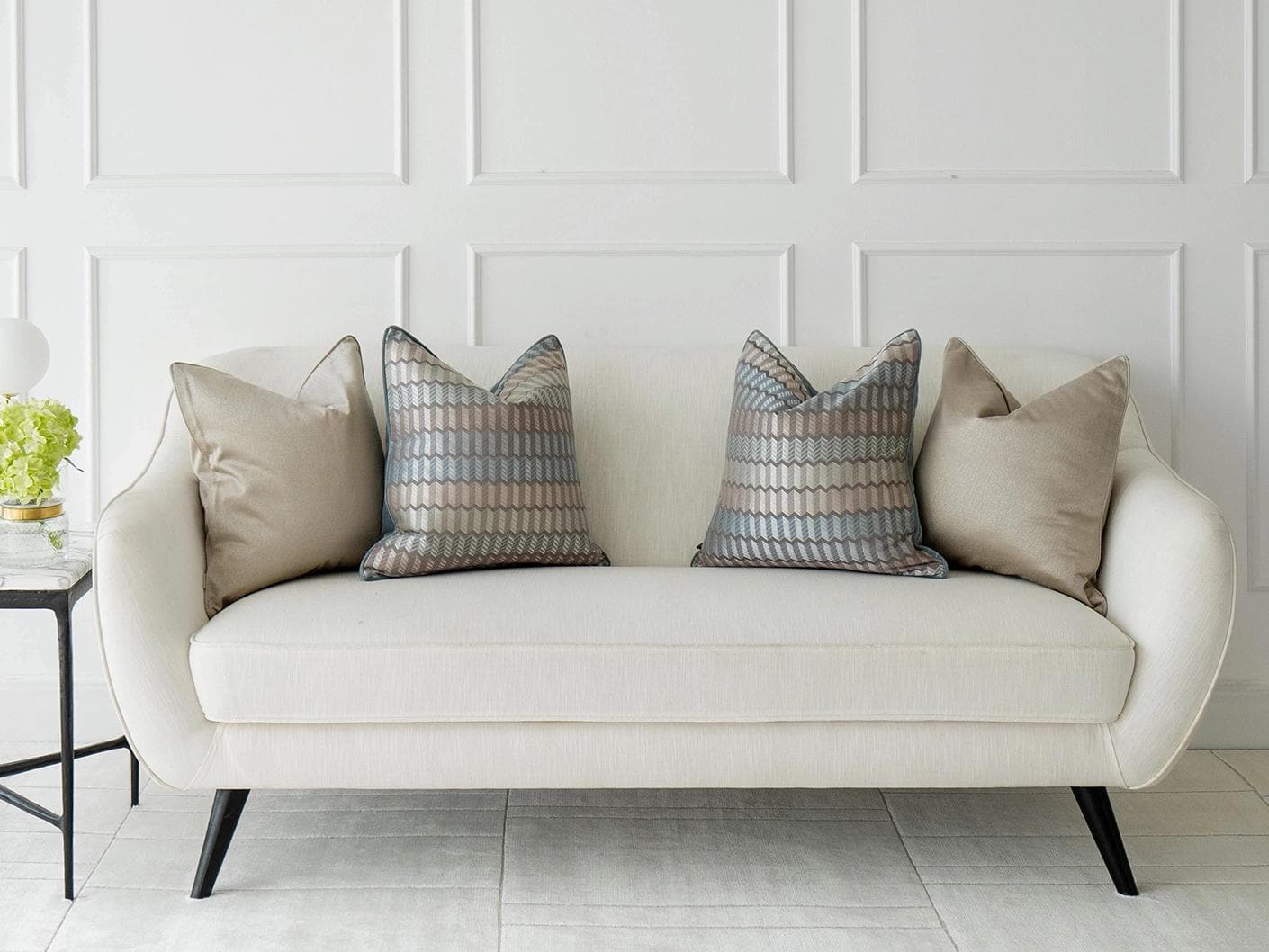 Evie Bundle cushion in silver, blue, gold and beige, shown in a lifestyle front view as image 4