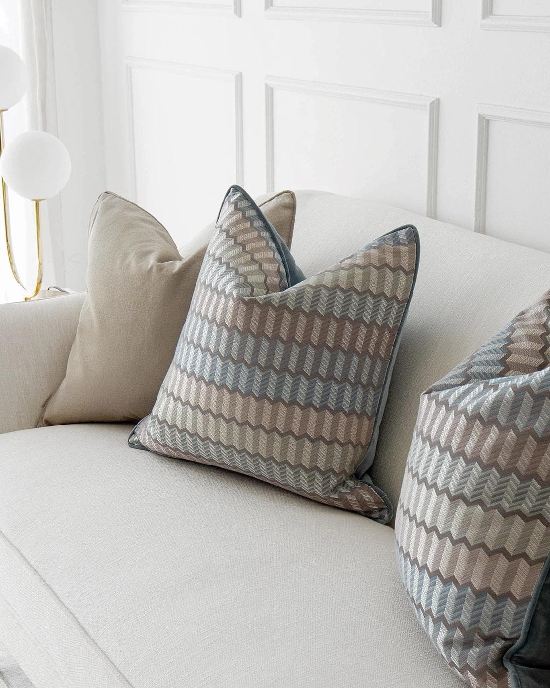 Evie Bundle cushion in silver, blue, gold and beige, shown in a lifestyle right view as image 5