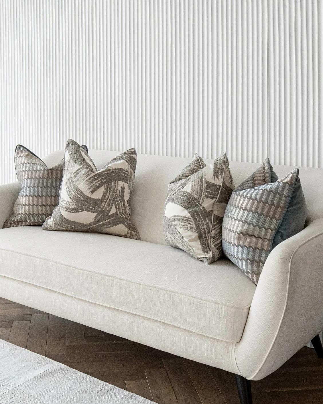 Meadow Bundle cushion in silver, blue, white and grey, shown in a lifestyle right view as image 2