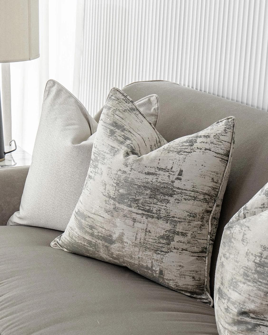 Ivanna Bundle cushion in silver, grey and white, shown in a lifestyle right view as image 5