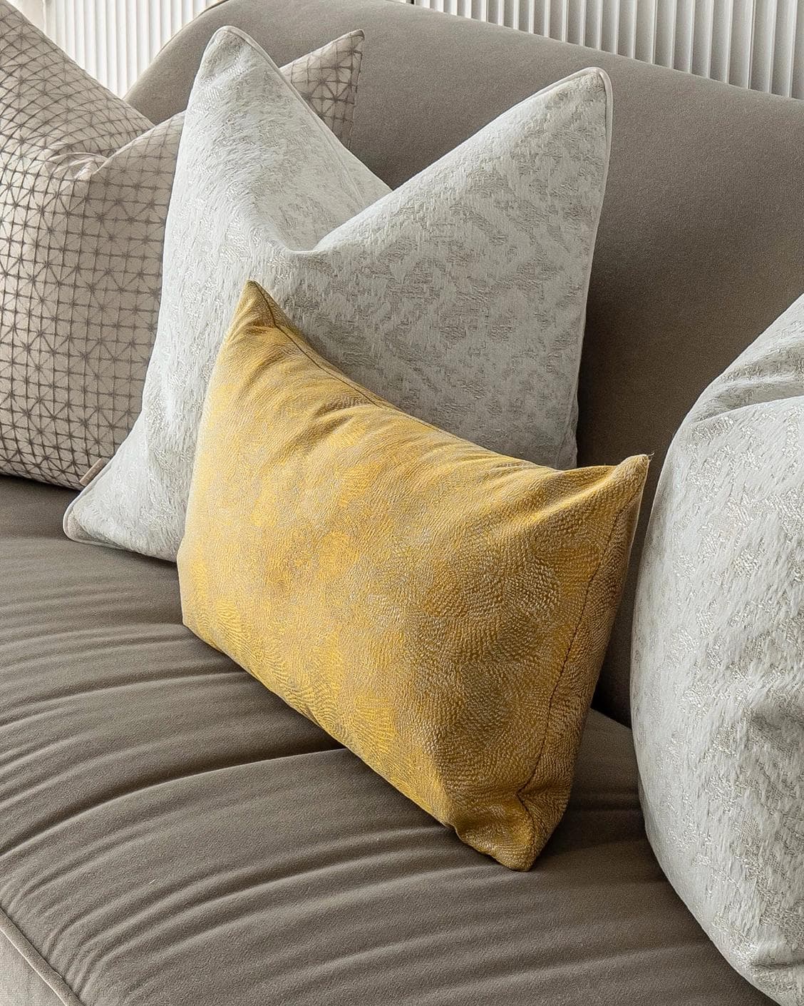 Ray Bundle cushion in silver, white and yellow, shown in a product right view as image 5