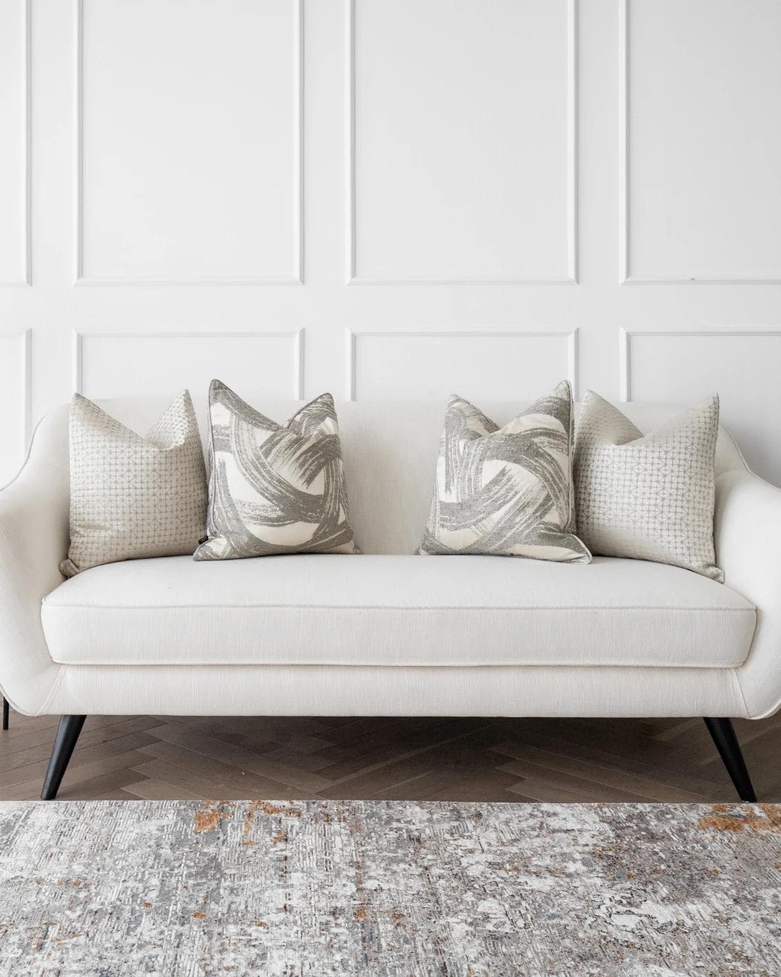Naya Bundle cushion in silver, white and grey, shown in a lifestyle front view as image 4