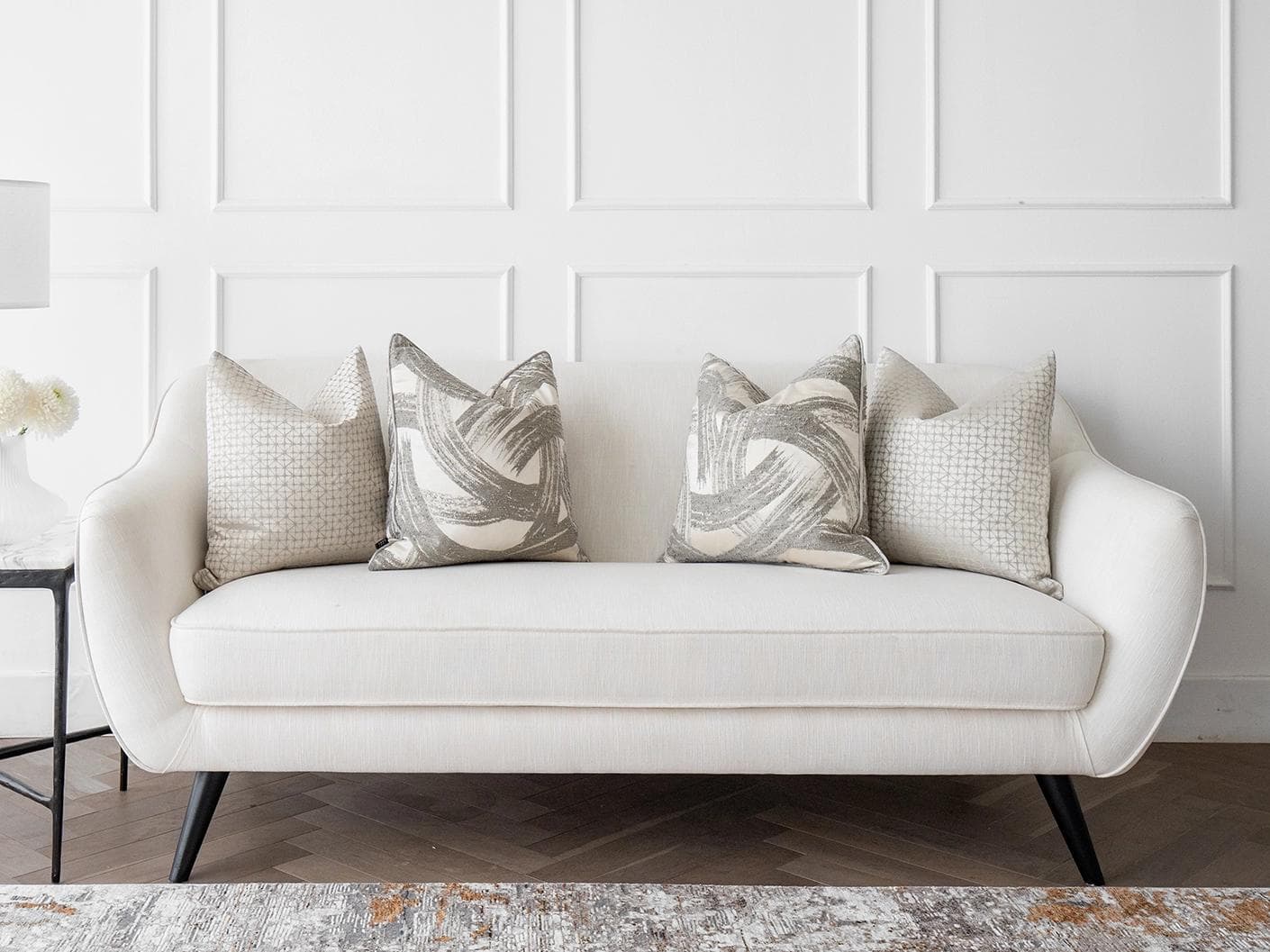 Naya Bundle cushion in silver, white and grey, shown in a lifestyle front view as image 4