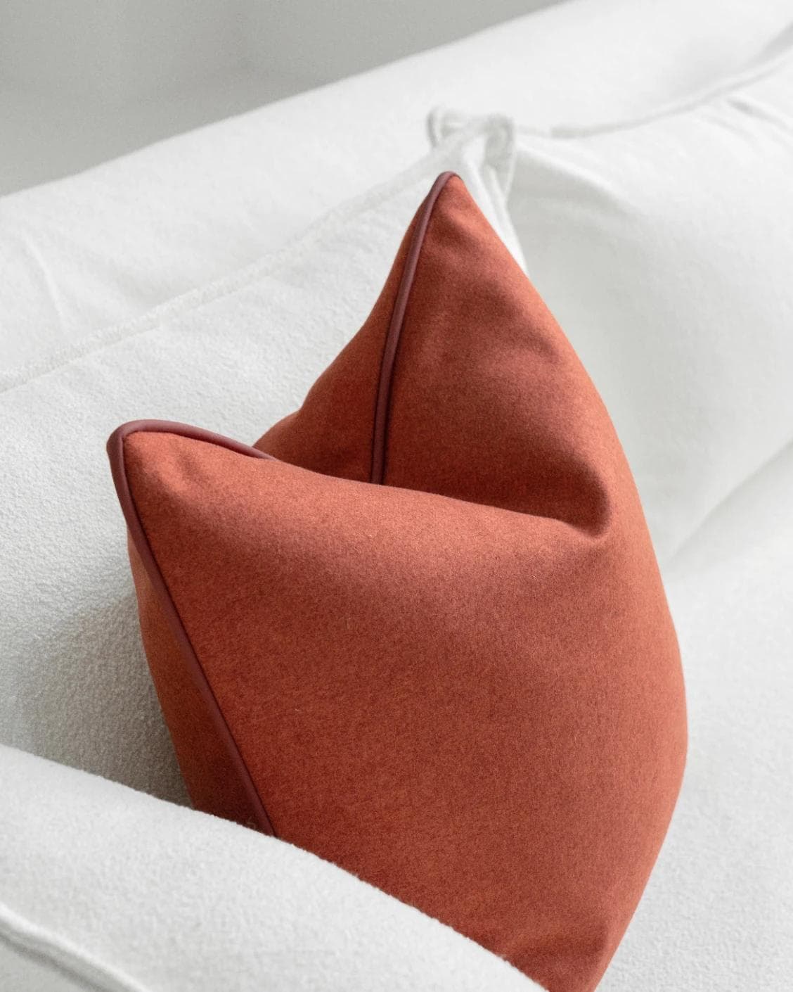 Silvie Scarlet cushion in orange, shown in a lifestyle top view as image 5