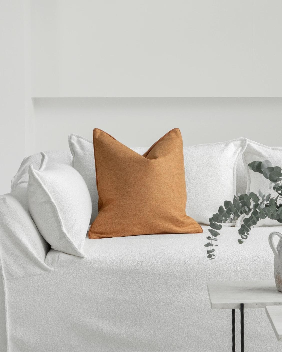 Silvie Tangelo cushion in rust, shown in a lifestyle front view as image 4