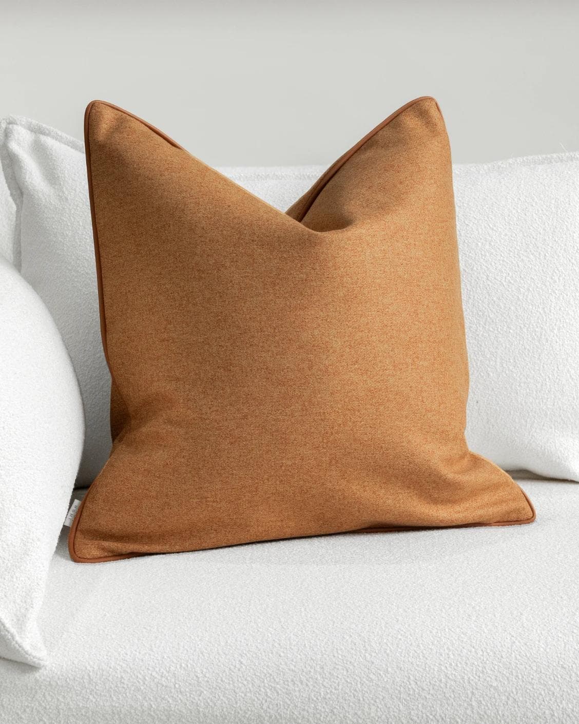 Silvie Tangelo cushion in rust, shown in a lifestyle front view as image 2