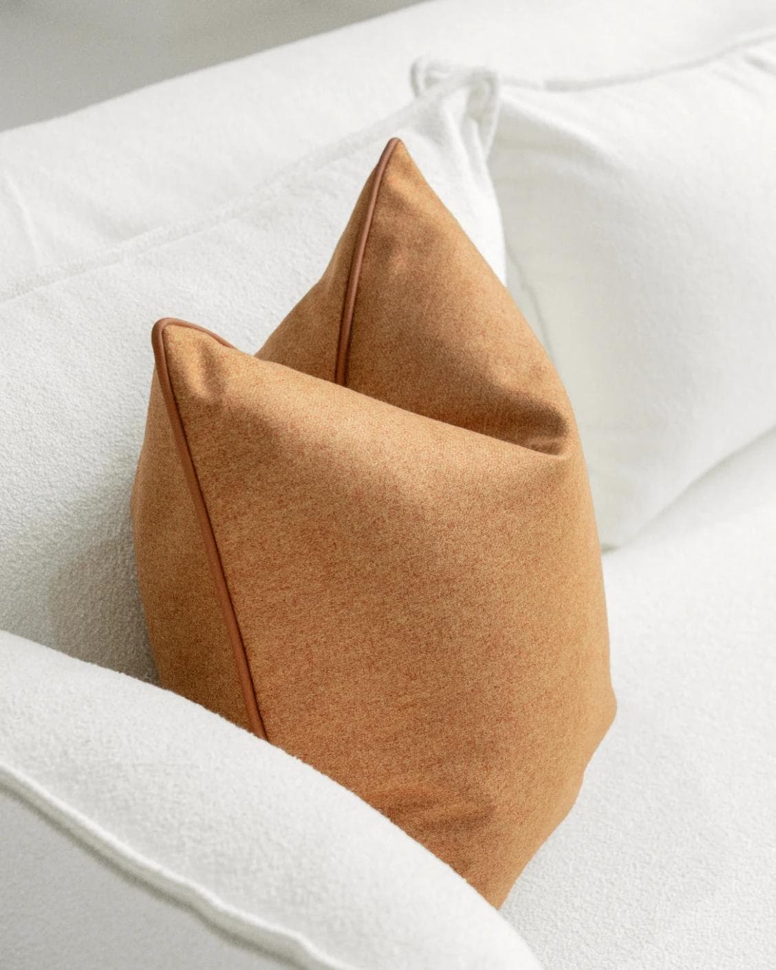 Silvie Tangelo cushion in rust, shown in a lifestyle left view as image 5