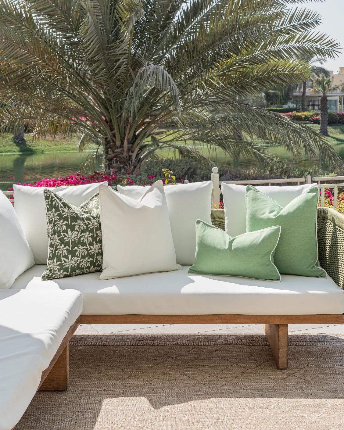 Sina Bundle cushion in green and ivory, shown in a lifestyle front view as image 4