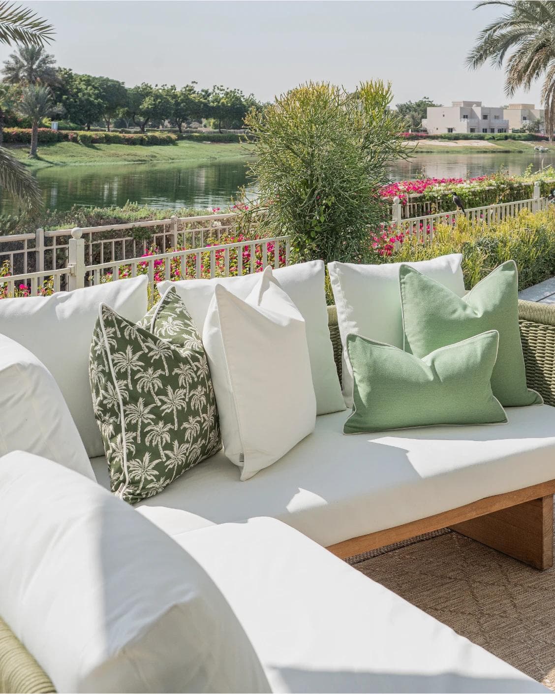 Sina Bundle cushion in green and ivory, shown in a lifestyle left view as image 2