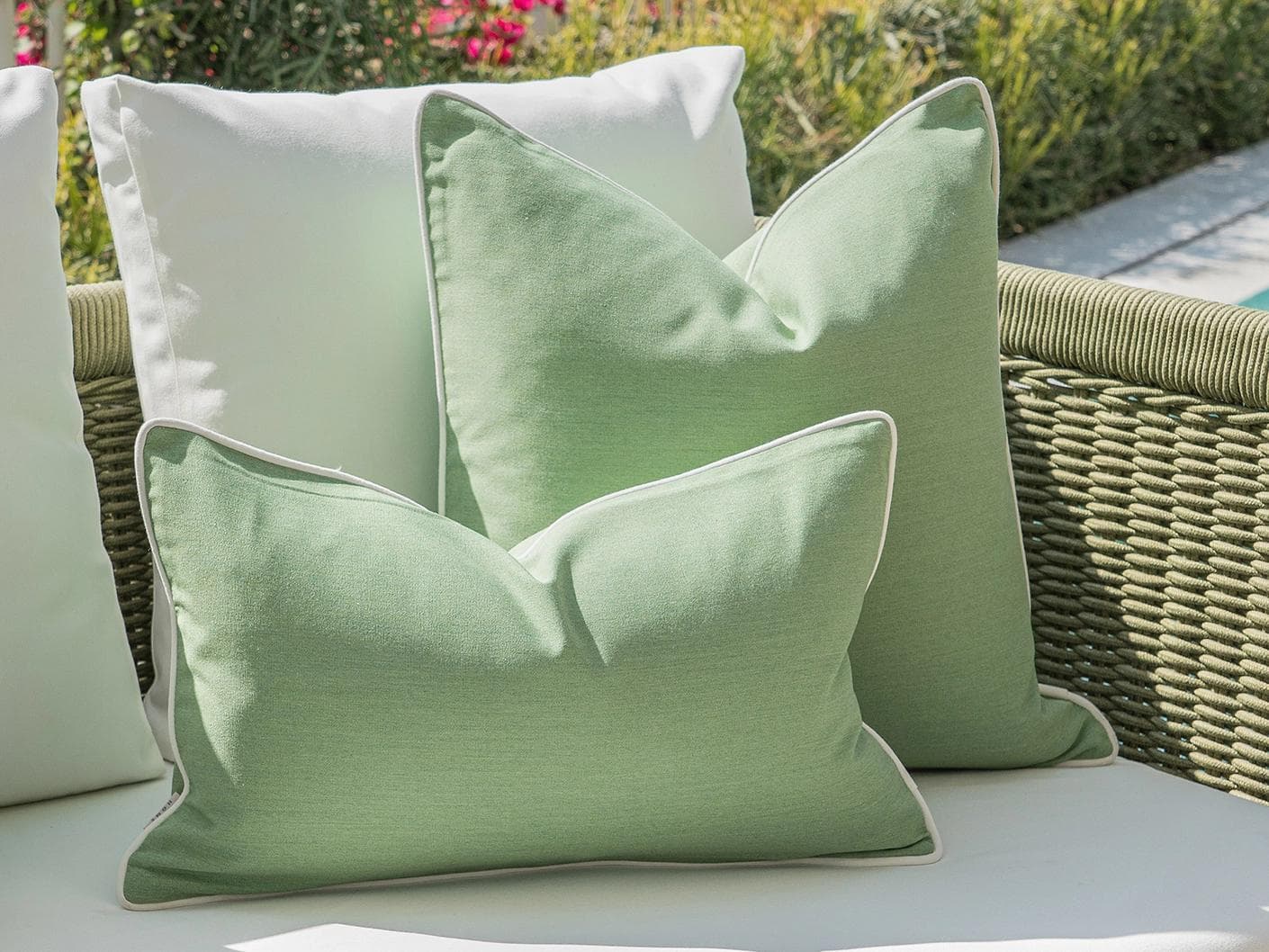 Sina Bundle cushion in green and ivory, shown in a lifestyle left view as image 5