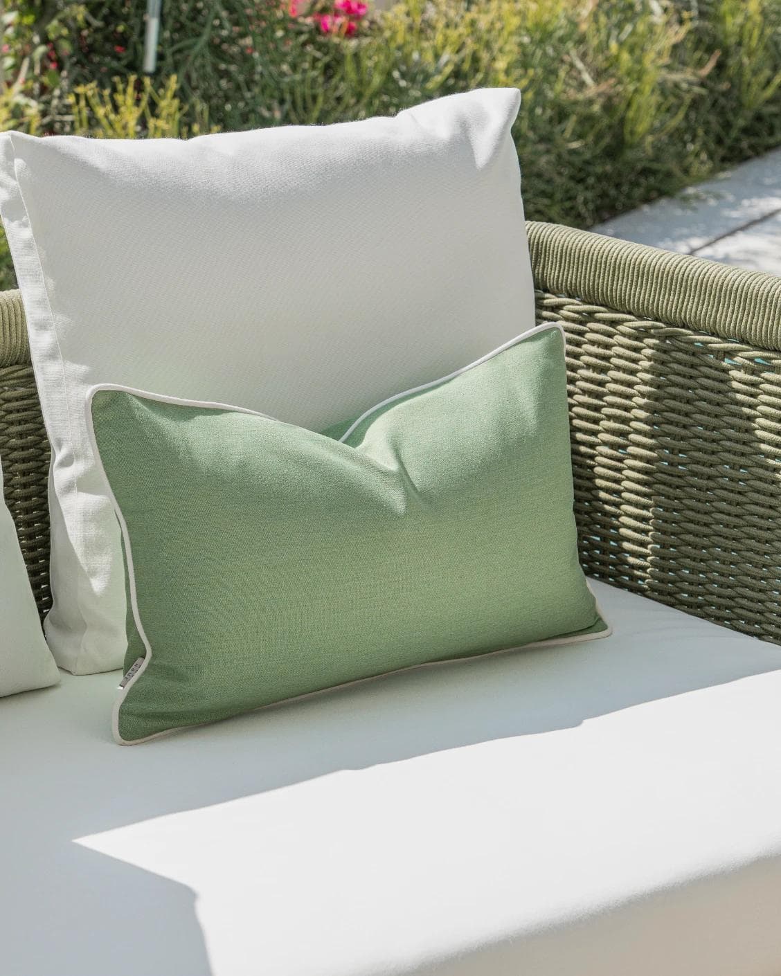 Sina Bundle cushion in green and ivory, shown in a lifestyle left view as image 6