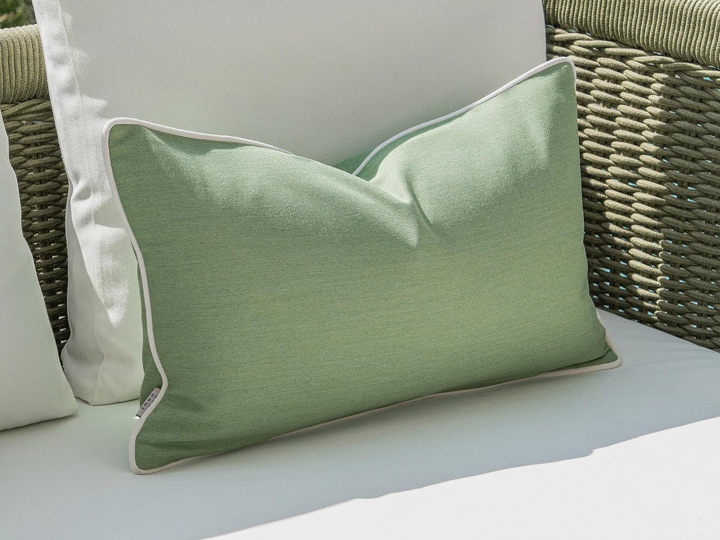 Sina Bundle cushion in green and ivory, shown in a lifestyle left view as image 6