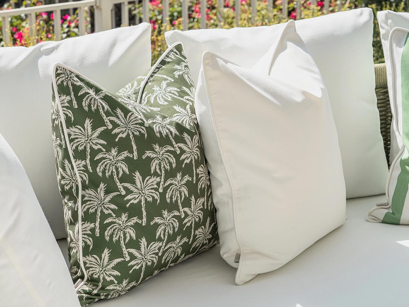 Sina Bundle cushion in green and ivory, shown in a lifestyle left view as image 7