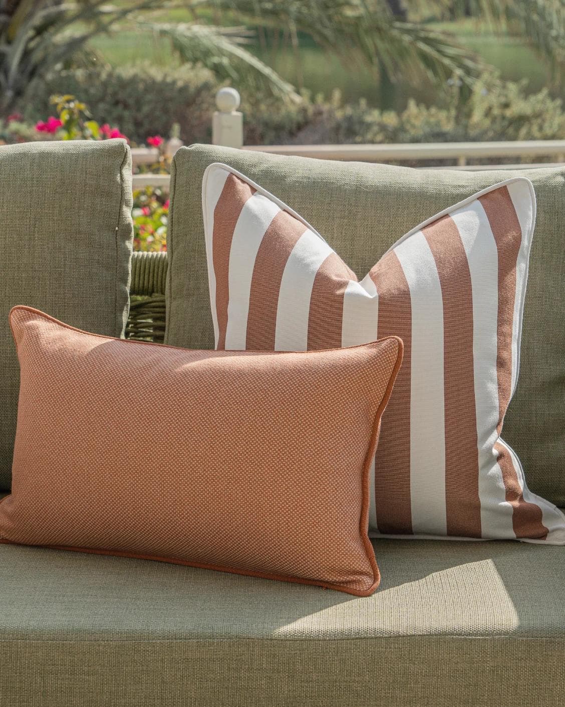 Sio Bundle cushion in rust and ivory, shown in a lifestyle front view as image 5