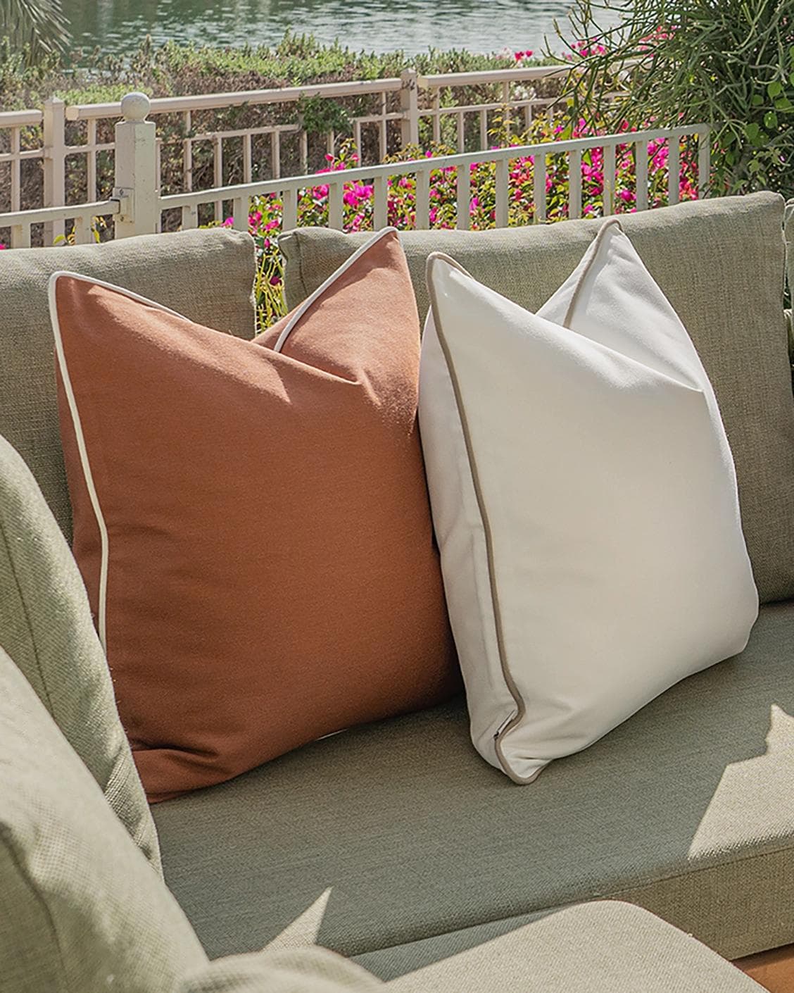 Sio Bundle cushion in rust and ivory, shown in a lifestyle left view as image 7