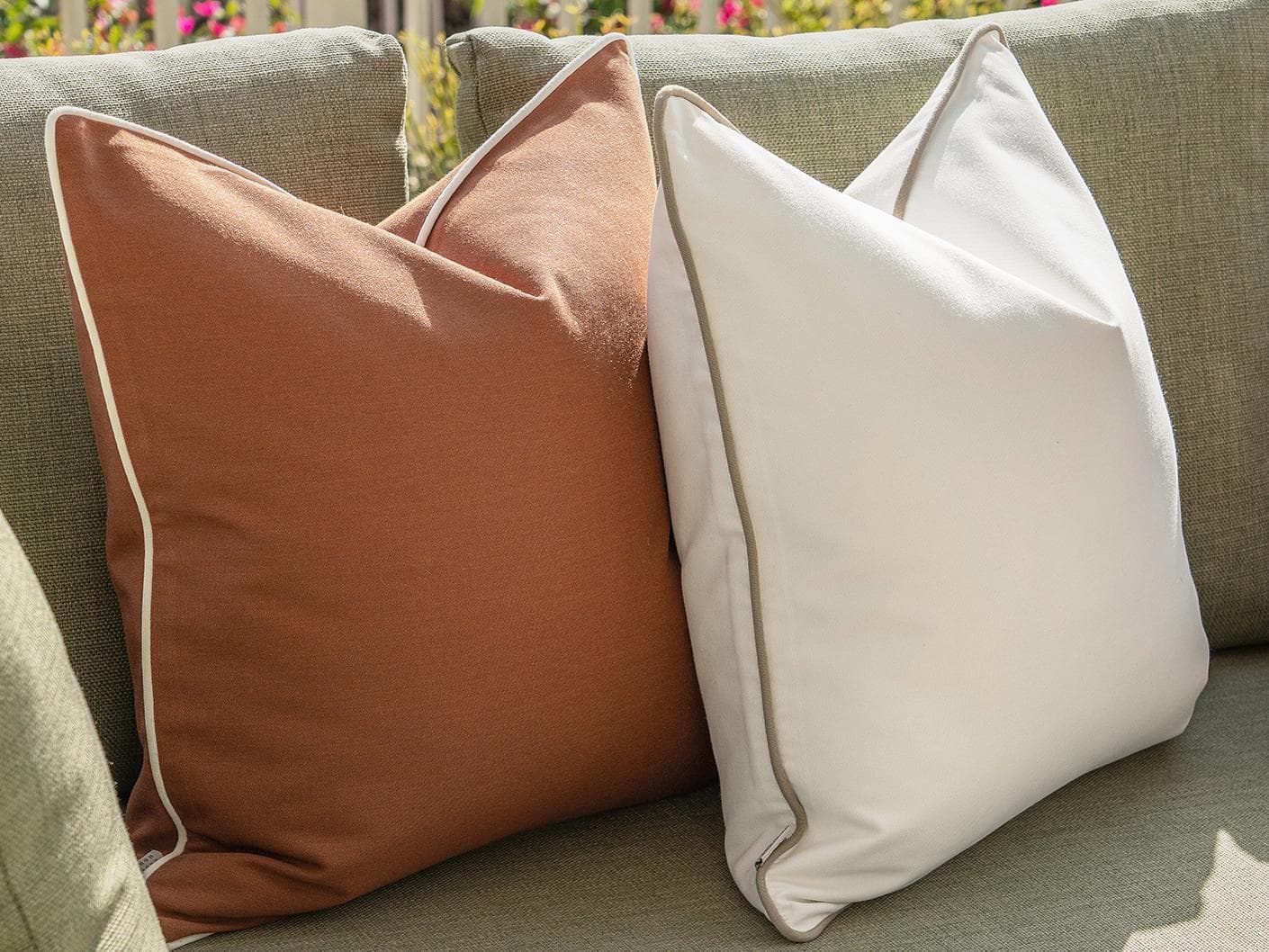 Sio Bundle cushion in rust and ivory, shown in a lifestyle left view as image 7