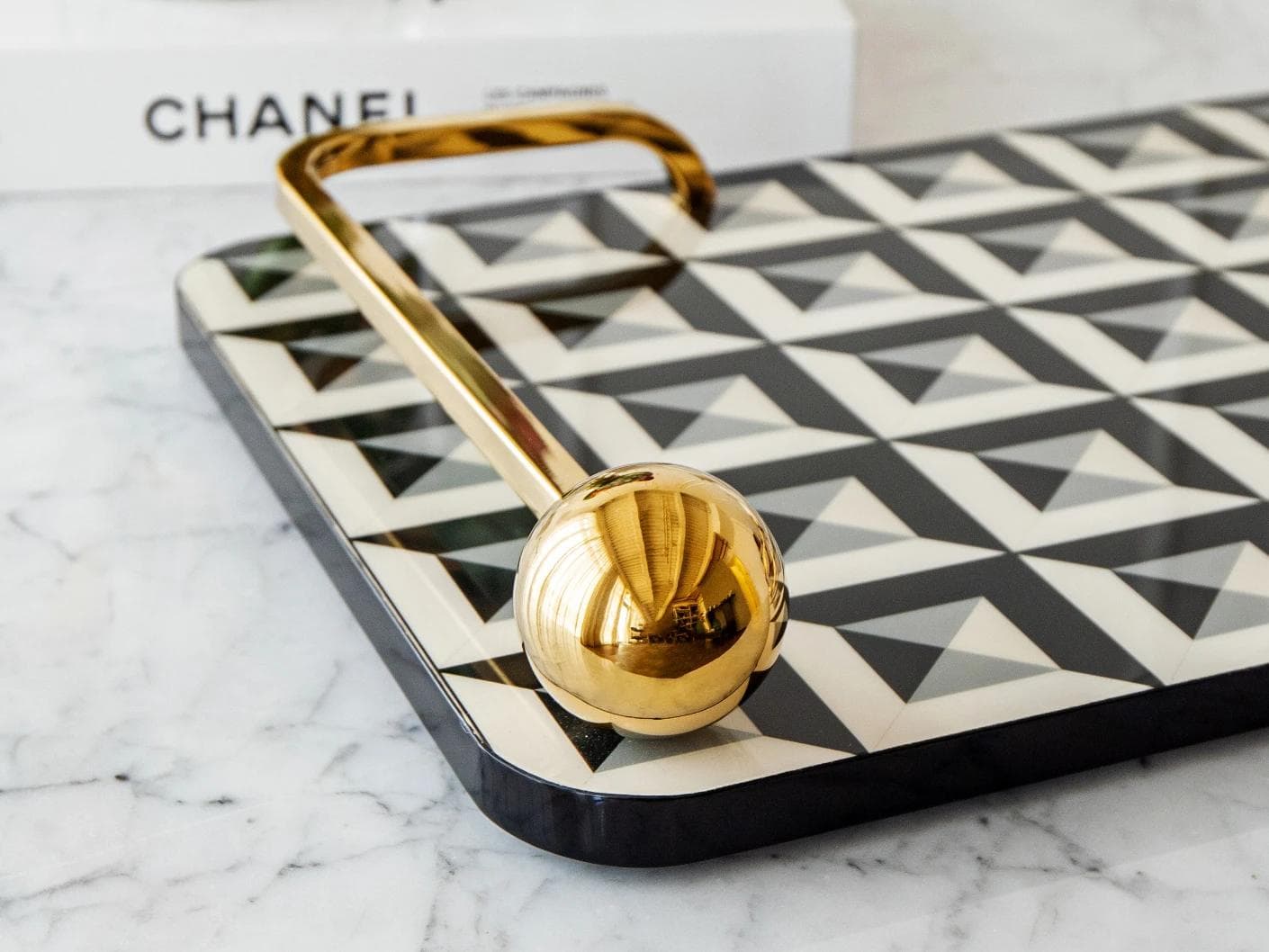 Stephen Bandiagara trays in black and gold, shown in a lifestyle close-up as image 4