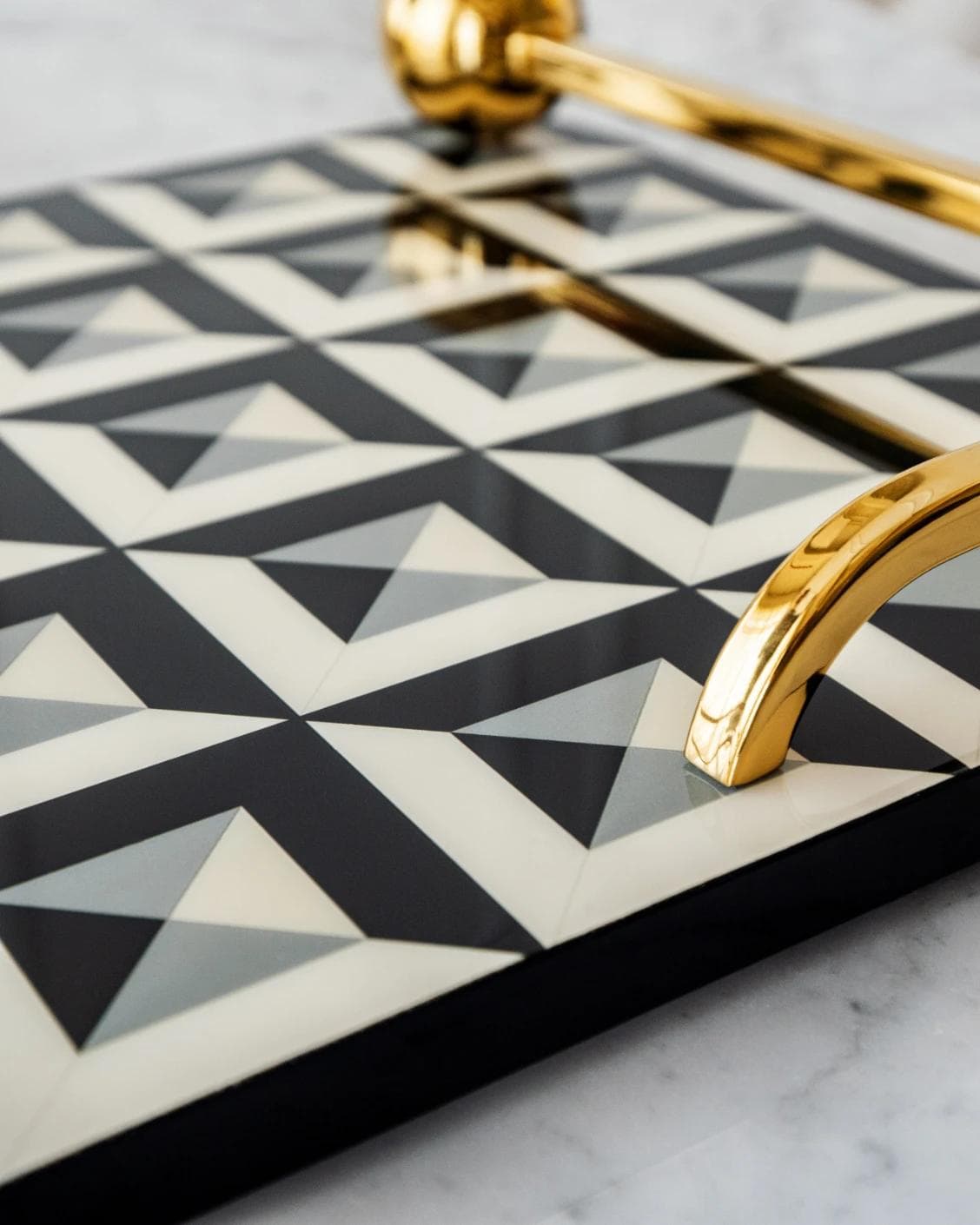 Stephen Bandiagara trays in black and gold, shown in a lifestyle close-up as image 5