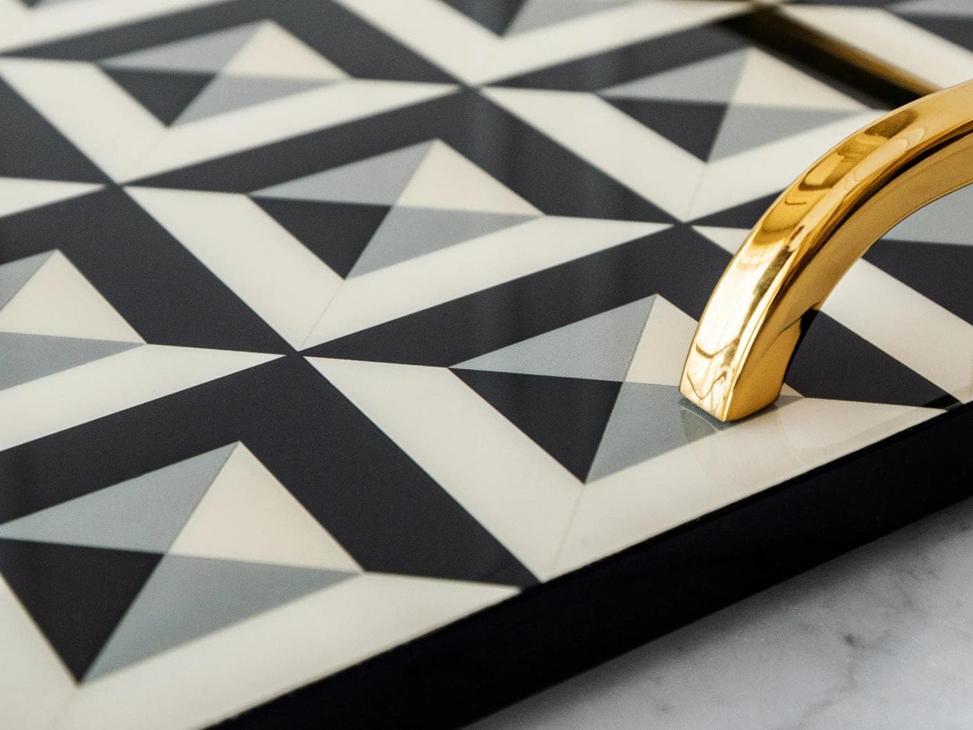 Stephen Bandiagara trays in black and gold, shown in a lifestyle close-up as image 5