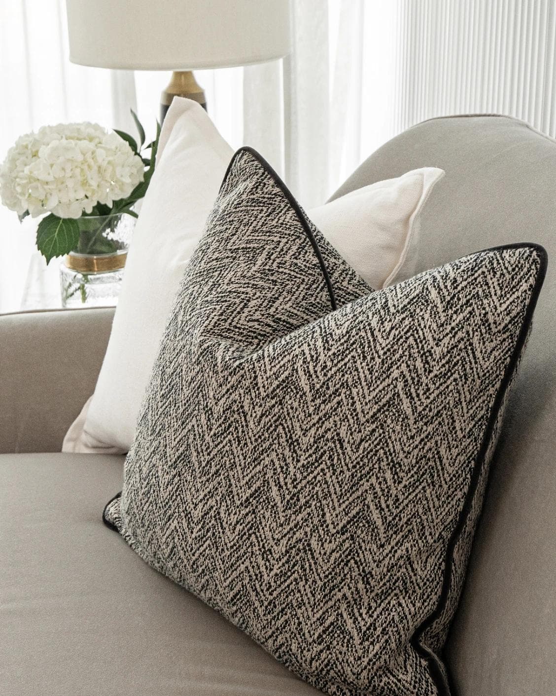 Rusman Bundle cushion in black and white, shown in a lifestyle right view as image 6