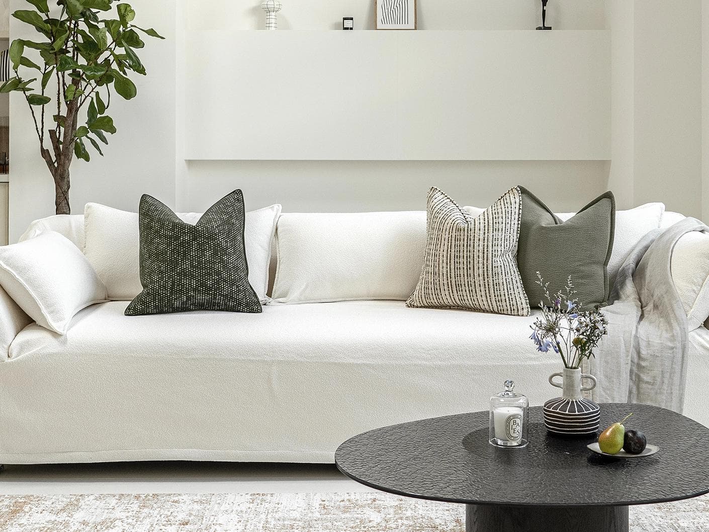 Suki Bundle cushion in green and beige, shown in a lifestyle front view as image 4