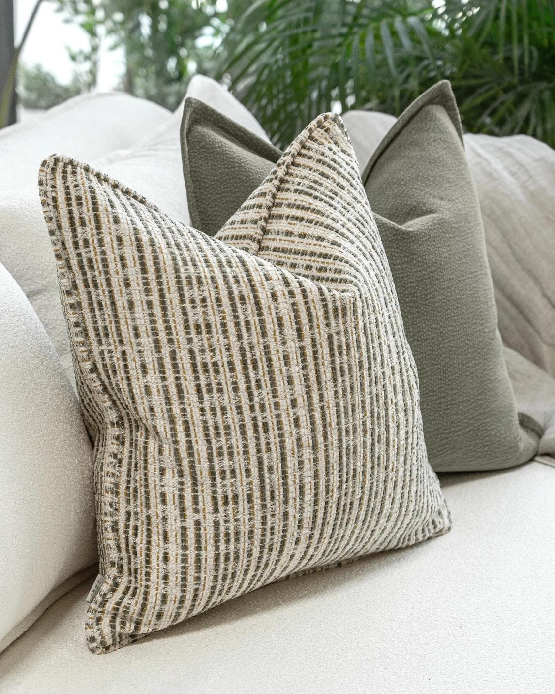 Suki Bundle cushion in green and beige, shown in a product left view as image 7