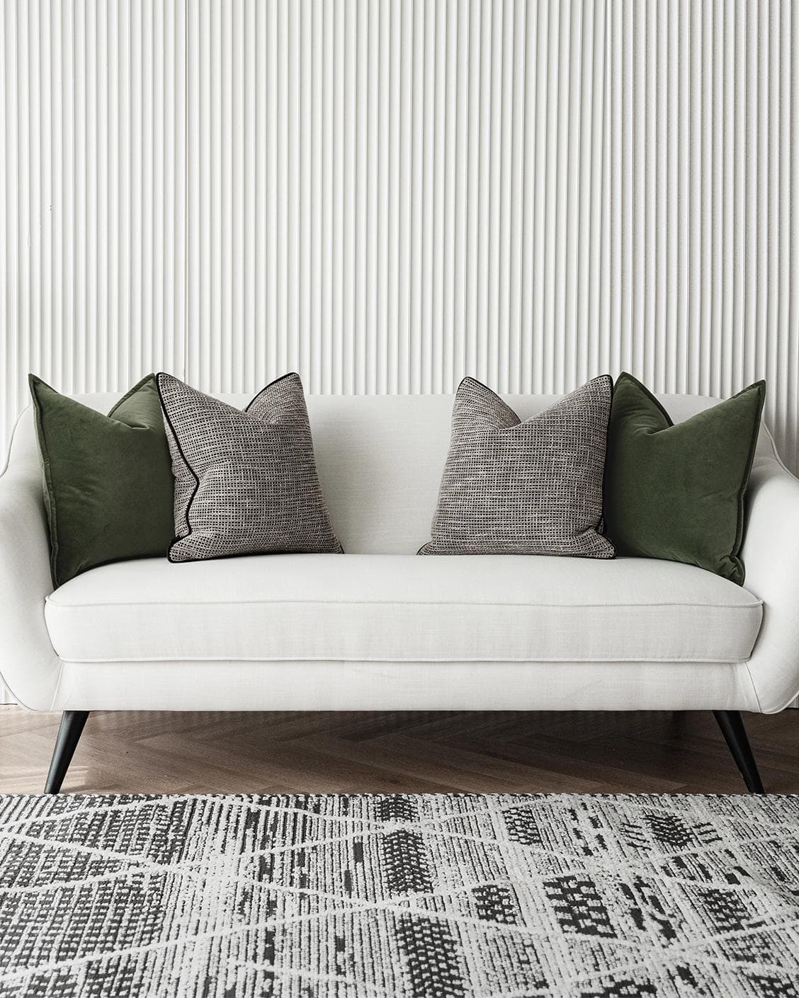 Susi Bundle cushion in green and black, shown in a lifestyle front view as image 4