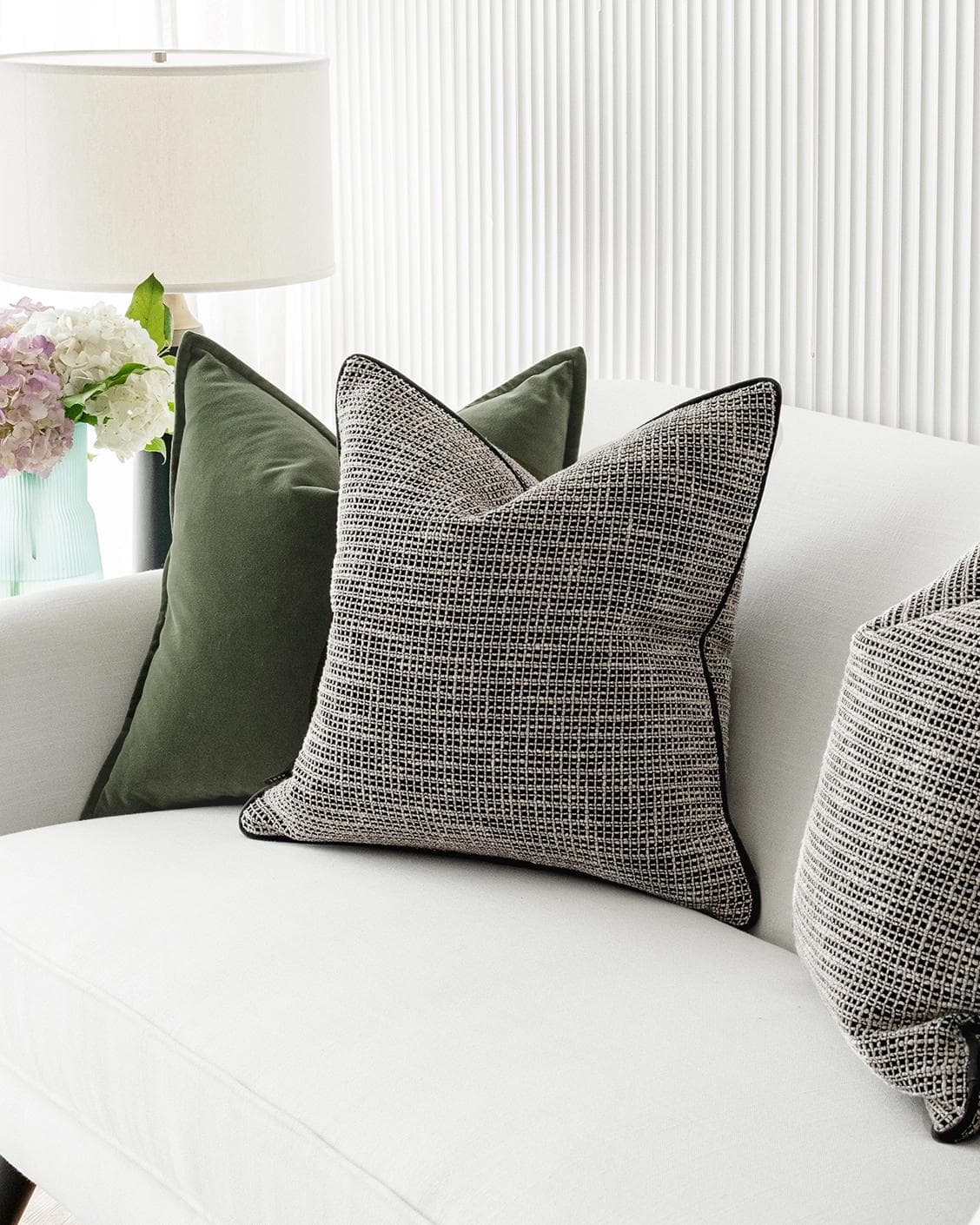 Susi Bundle cushion in green and black, shown in a lifestyle right view as image 5