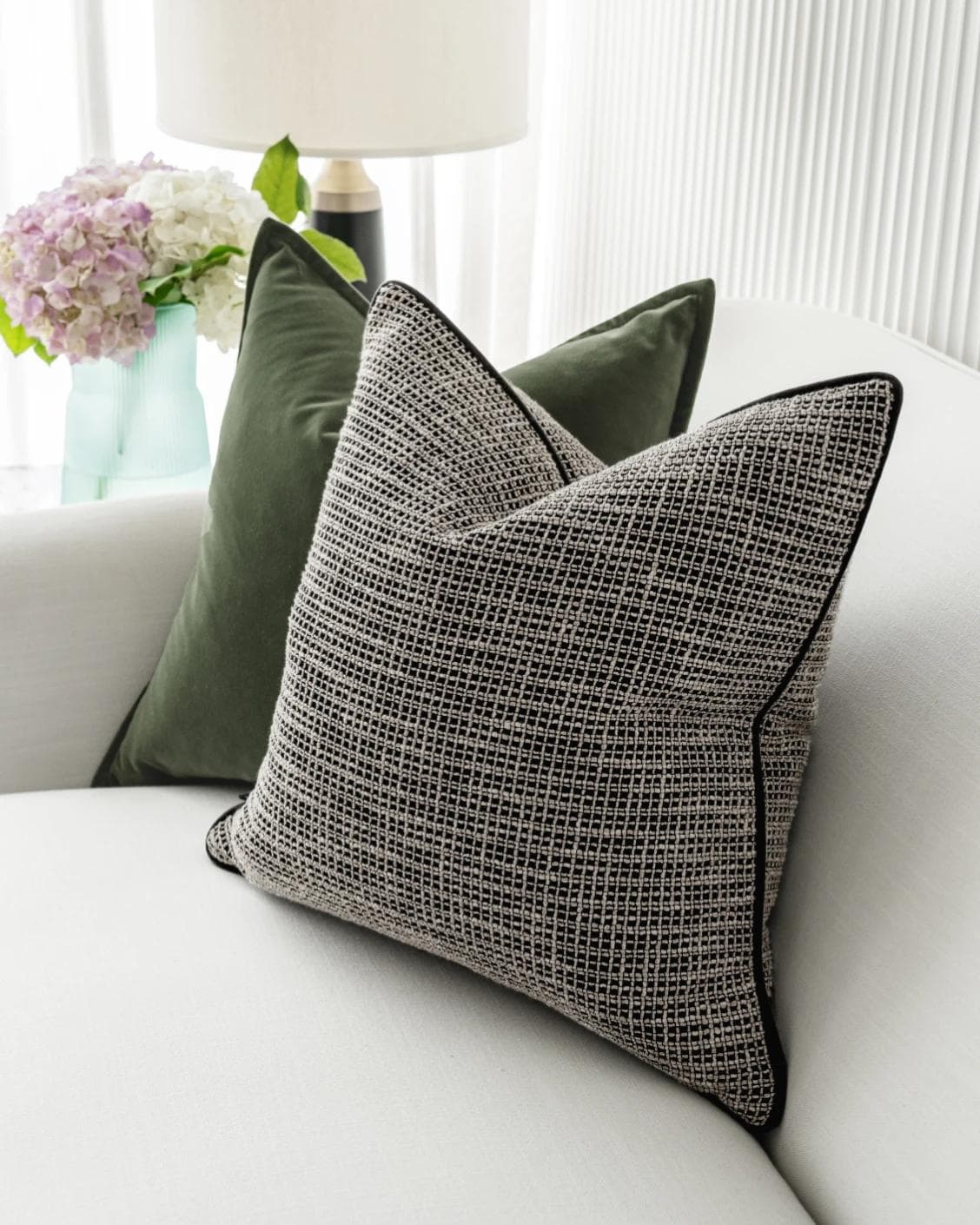 Susi Bundle cushion in green and black, shown in a lifestyle right view as image 6