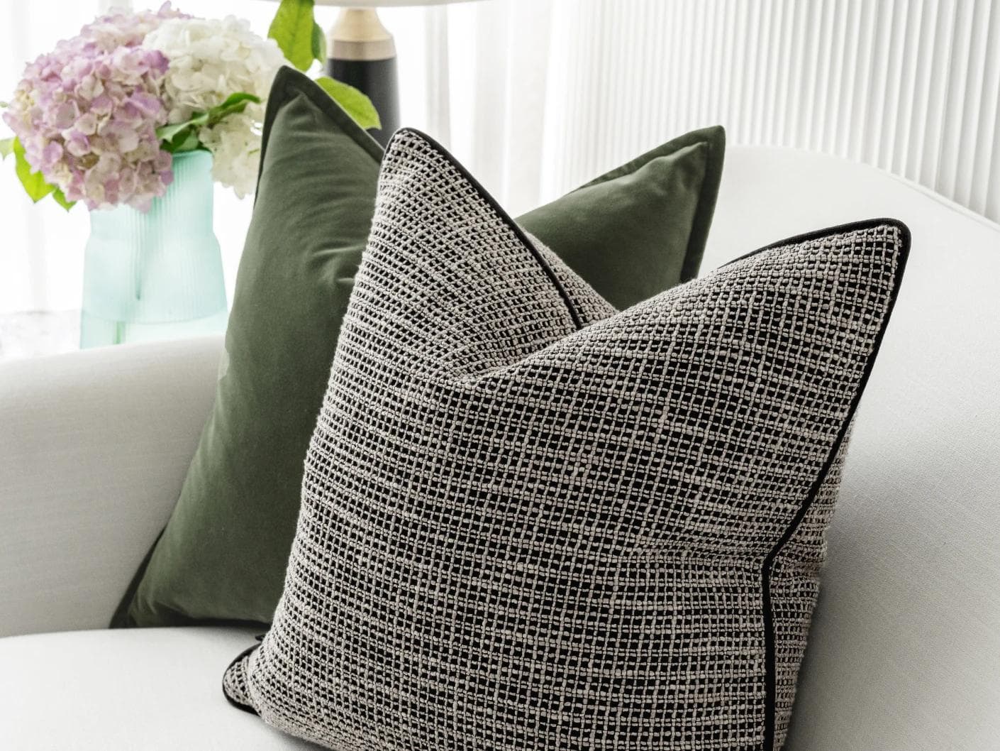 Susi Bundle cushion in green and black, shown in a lifestyle right view as image 6