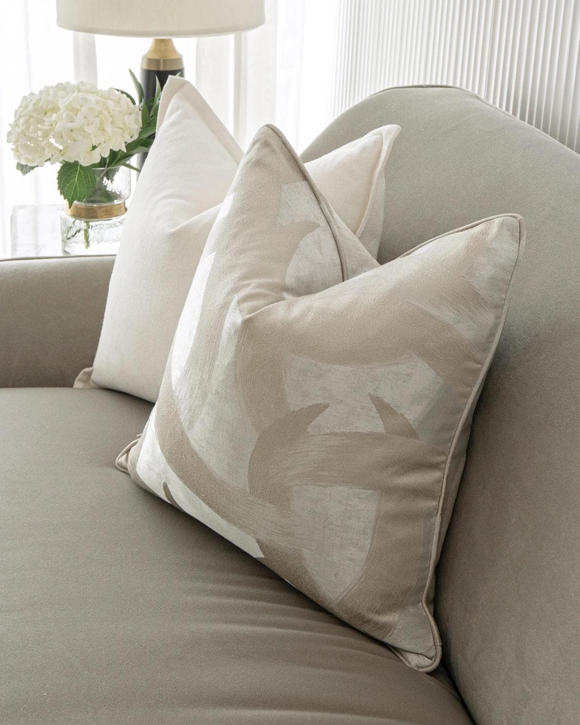 Landers Bundle cushion in white, silver and beige, shown in a lifestyle right view as image 6