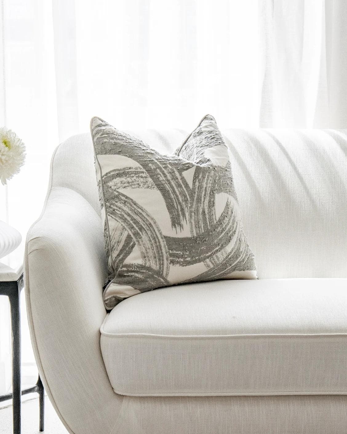 Tanya Laurent cushion in white and grey, shown in a lifestyle front view as image 4